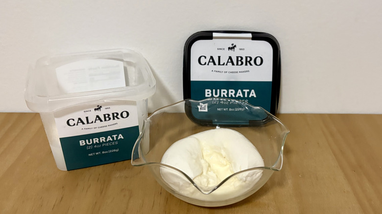 Open container of Calabro burrata next to serving bowl