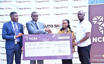 NCBA Head of Marketing, Edgar Tusiime and Head of Asset Financing, Adad Iraguha handover a cheque of ugx 100m to the Auto Show Kampala team as part of their platinum sponsorship deal