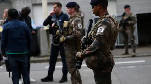Reuters Police and army stand outside the school. 