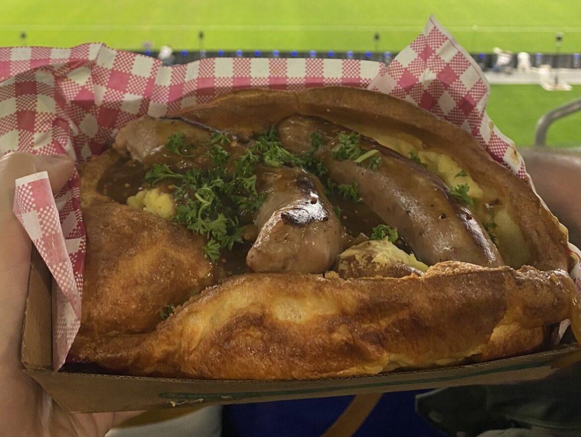Sausages, mash potatoes and gravy inside a Yorkshire pudding