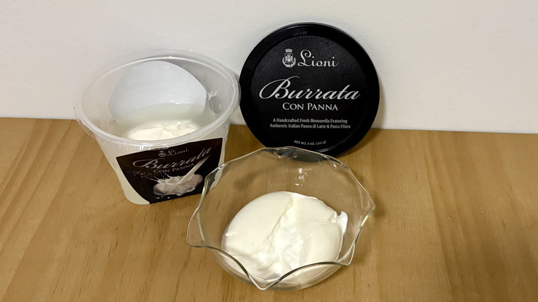 Open container of Lioni burrata con panna next to serving bowl