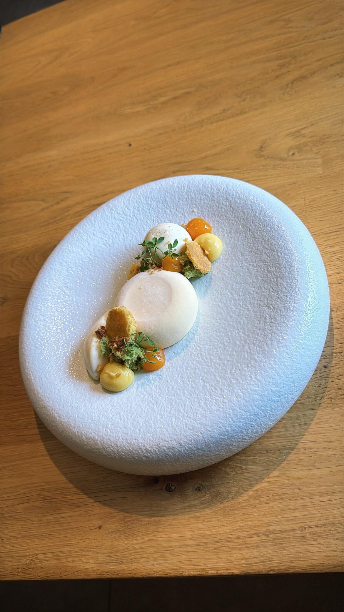 Passionfruit mousse, gel and ganache, white chocolate mousse,Breton mango crisp and crumble, spongecake pistachio