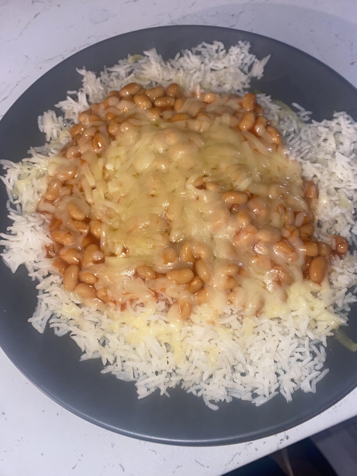 My struggle meal, rice with beans, cheddar cheese and butter