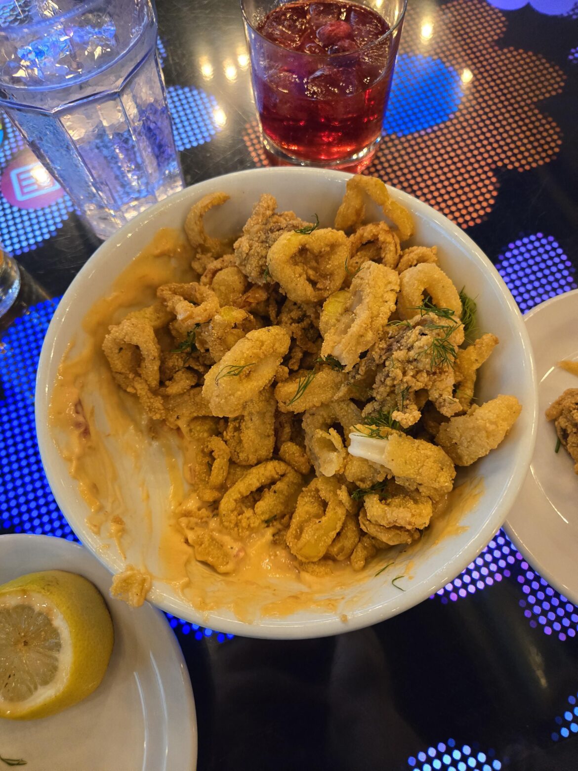 Our calamari was served in a bowl with all the "dipping" sauce smeared onto half of the inside of the bowl. 3/4 were dry and had almost nothing left to dip, 1/4 was completely soggy.