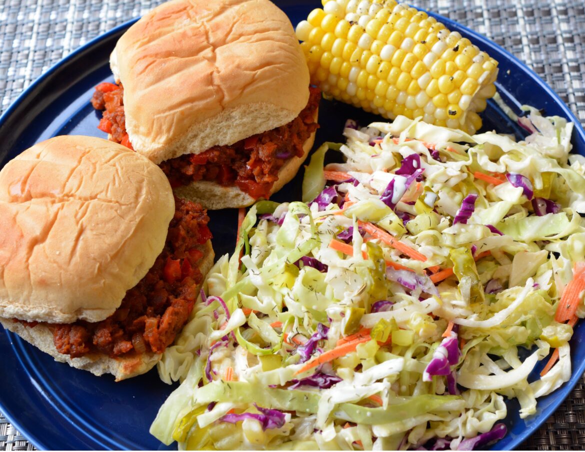(495 cal, 37 g protein) creamy dill pickle slaw, two vegan sloppy joes on keto buns, and corn