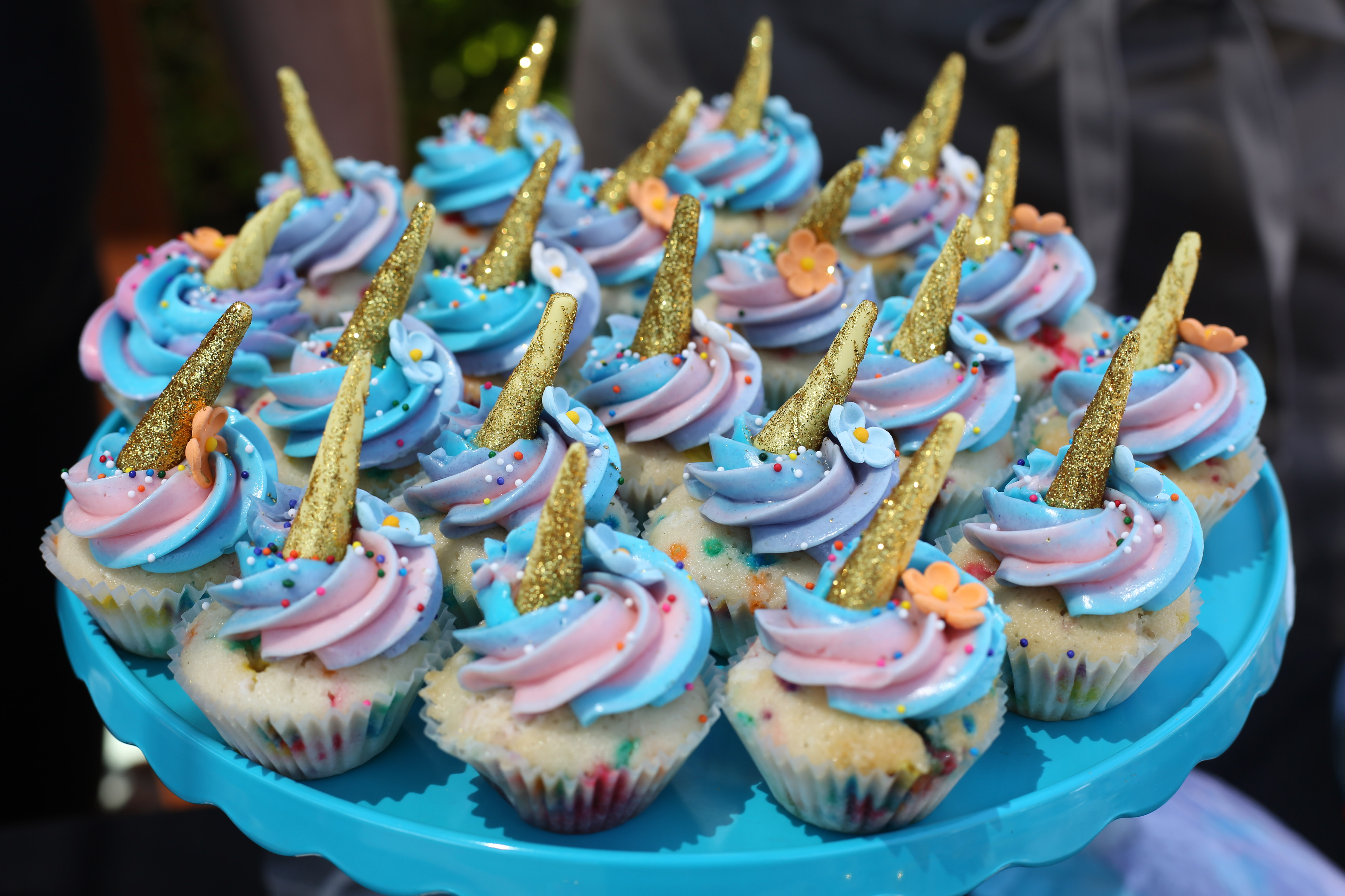 Sweet Cheeks Baking Co. and Diner's Unicorn Cupcakes, featuring swirled Italian buttercream and an edible unicorn horn.