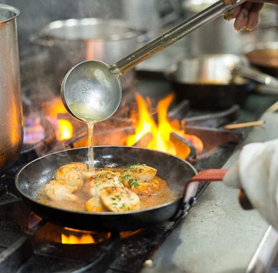 A delicious meal being served over the grill at Don Giovanni, one of the best Italian restaurants in Manchester