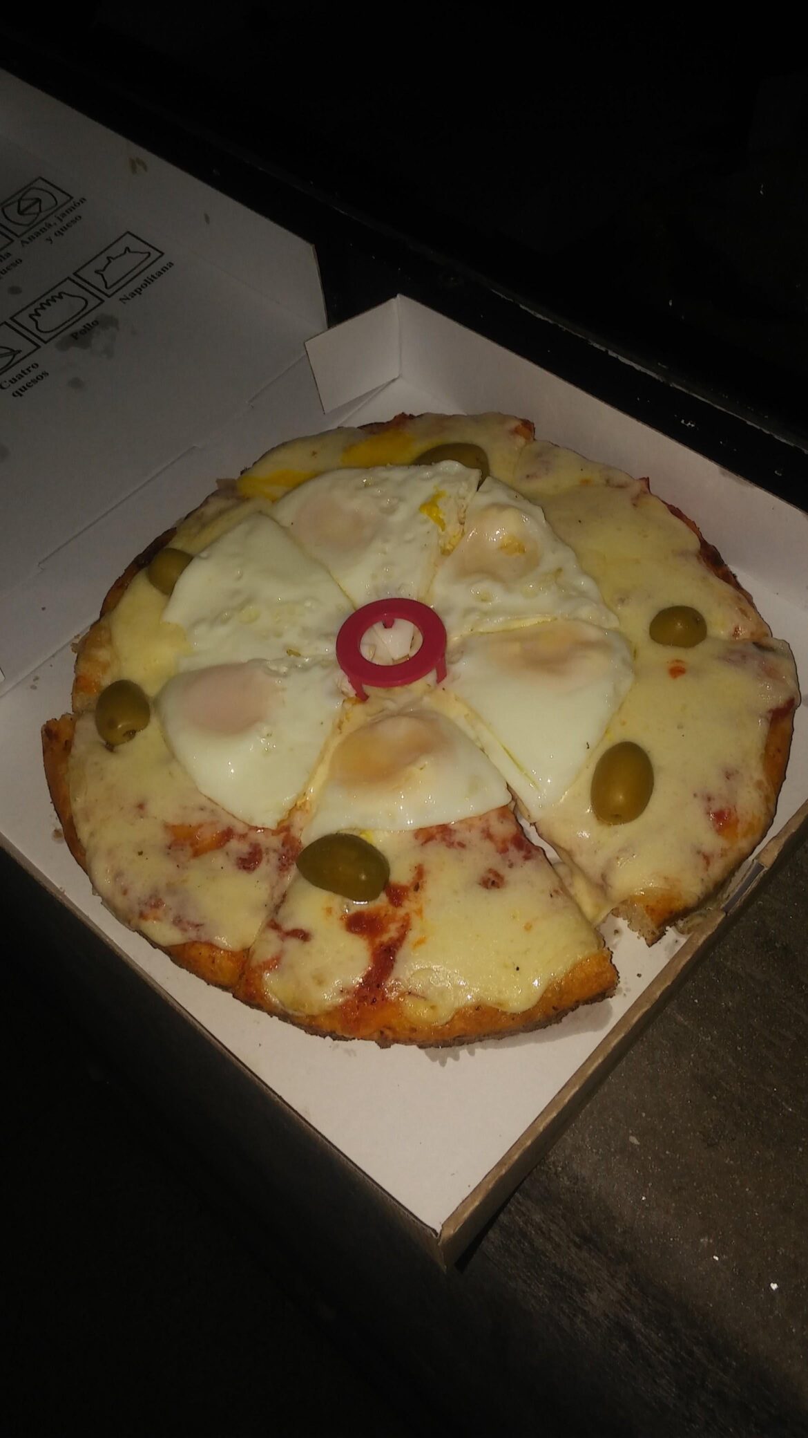 The cheese. The single olive on each slice. The egg placement.