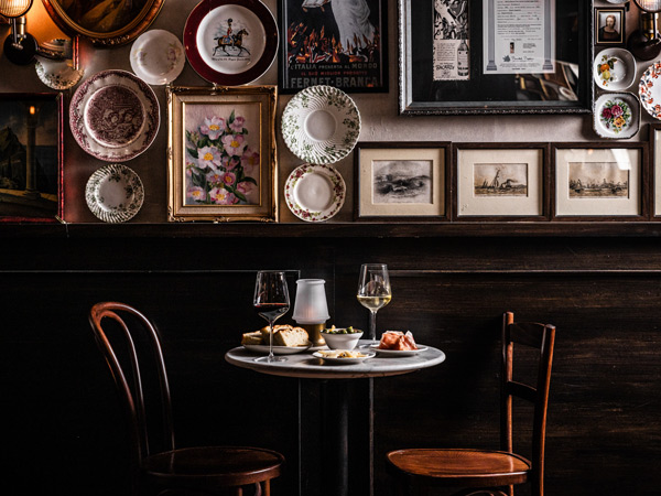 an Italian-inspired diner at Bistecca considered one of the best Italian restaurants in Sydney; pictured are plates and framed images of flowers and Italian historical photos