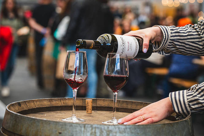 Person pouring a glass of wine at SicilyFEST