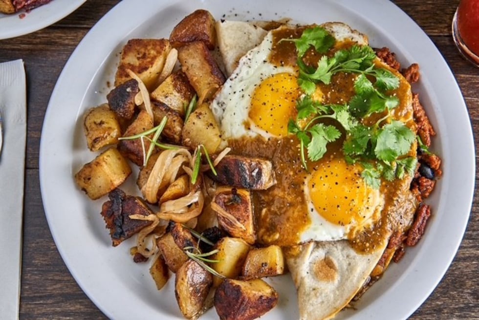 Huevos Rancheros is served with a flour tortilla, spicy chorizo, black beans, cheddar cheese,...