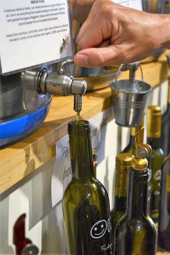 DSC_5758 The Happy Olive in Fairhope has developed a loyal following for its house-blends of olive oils, balsamic vinegars and mustards, which can be purchased by the bottle and jar or on tap. (Karim Shamsi-Basha / Alabama NewsCenter)