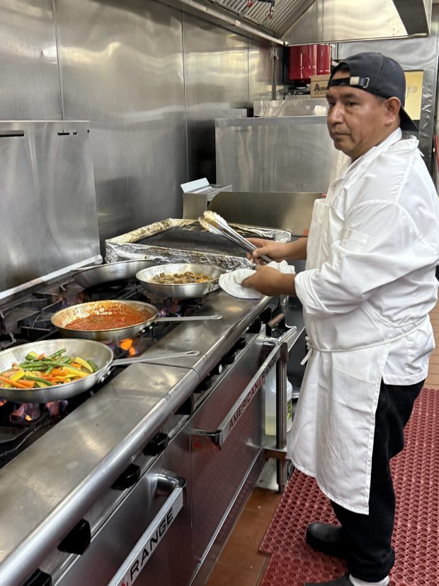 Buona Sera Executive Chef Pedro Perez puts his advanced culinary skills in action in the kitchen of the new Buona Sera Ristorante in Springfield. (PEG DEGRASSA/ DAILY TIMES)