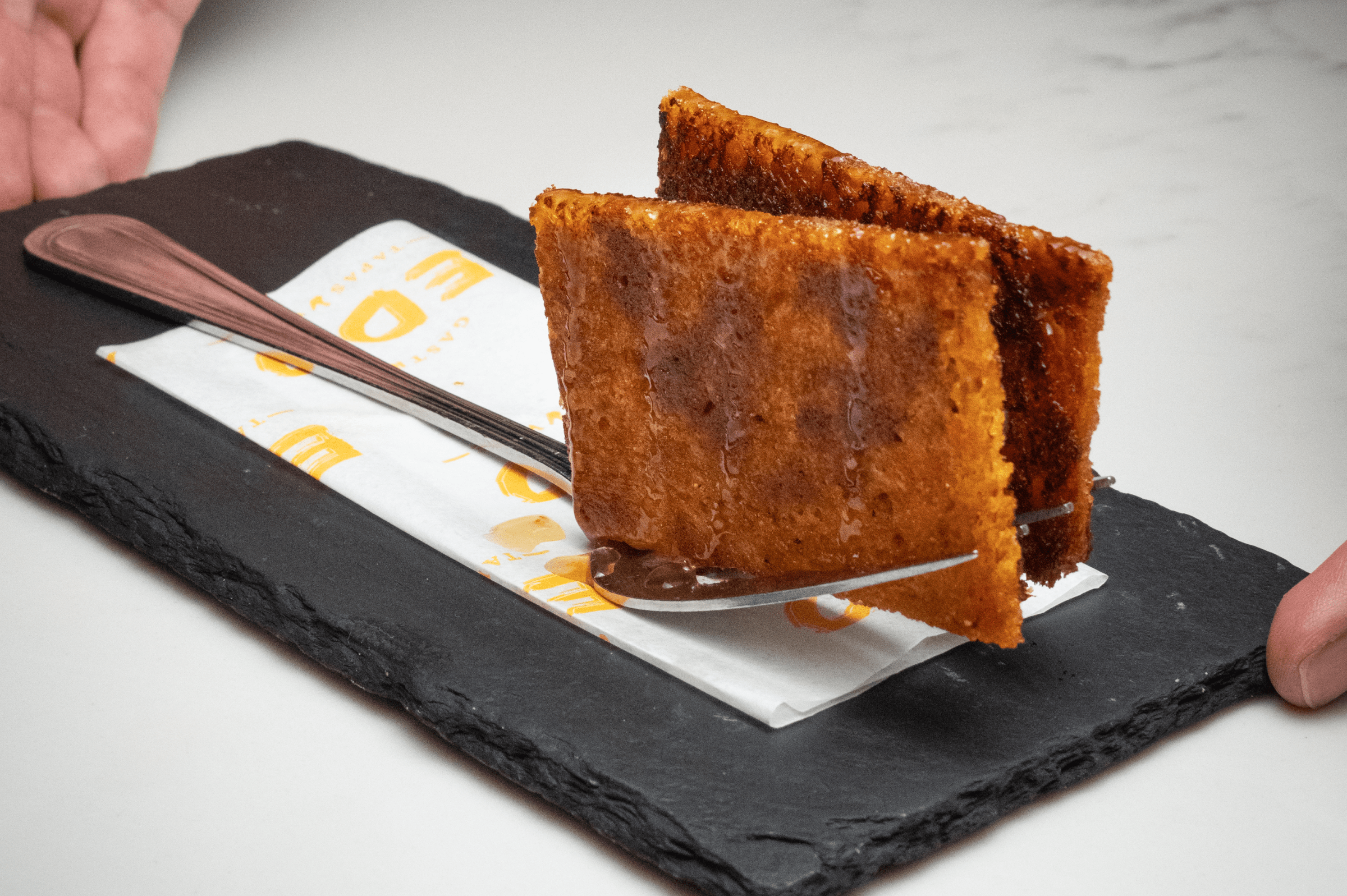 Bikini paninis slipped between fork tines at EDO Tapas & Wine.