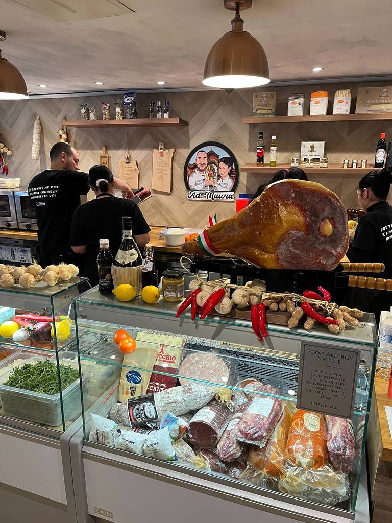 deli counter with selection of meats like salami with leg of ham on top inside ad maiora samdwich shop on tib street, manchester
