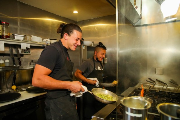 Chef and owner Michele Belotti, left, cooks Pasta alla Ligure at his Italian restaurant Belotti Ristorante in Oakland, Calif., on Wednesday, Sept. 21, 2022. (Ray Chavez/Bay Area News Group)