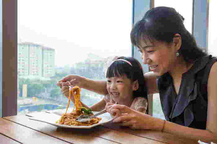 mum and daughter eating pasta - italian restaurants singapore