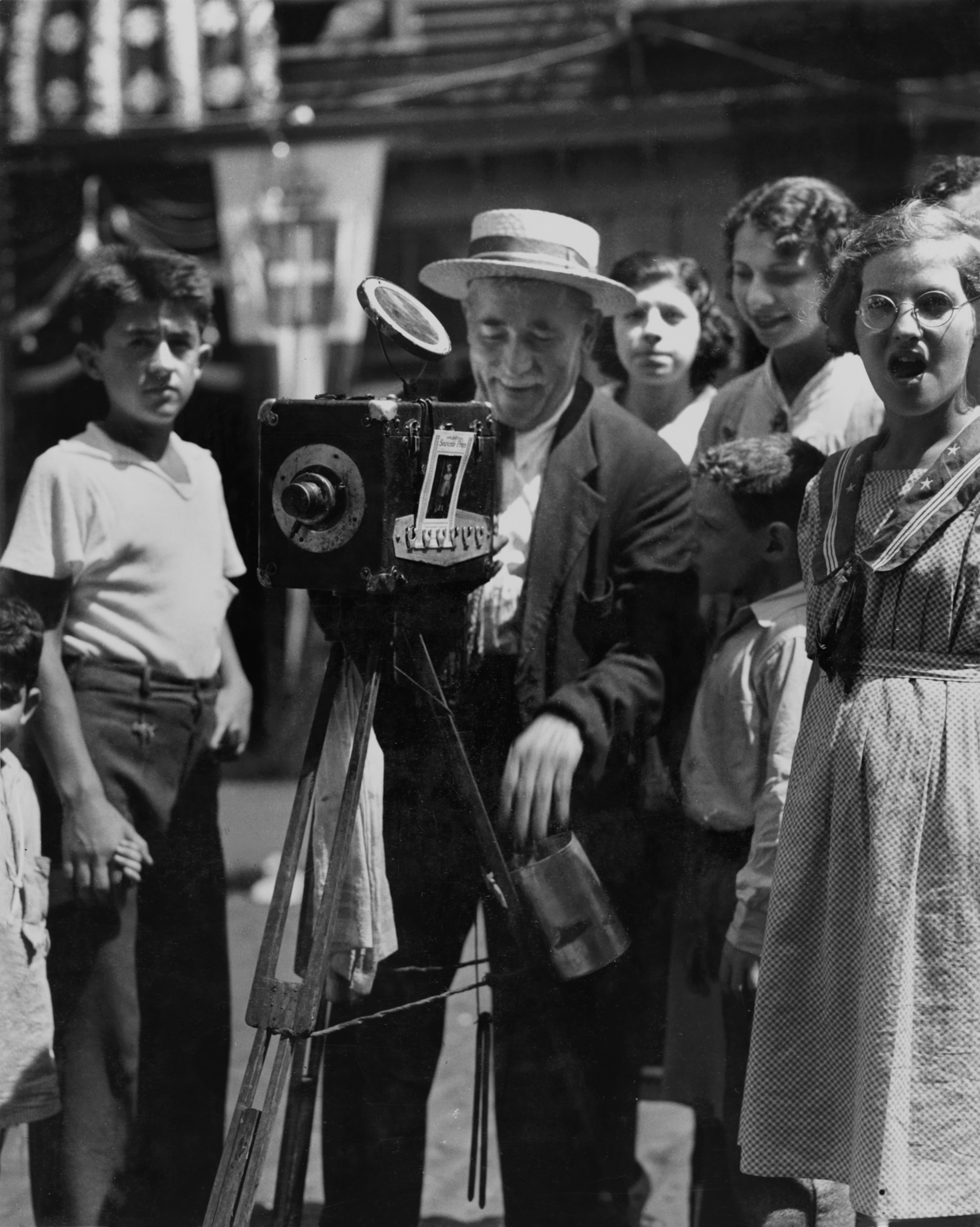 A man with a camera ready to take photos on the street.