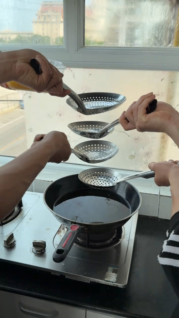 filtering egg into boiling oil