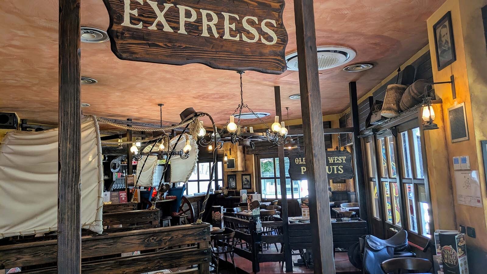 The inside of the restaurants tends toward the kitschy, with a saloon-like feel and a jumble of various Western-themed art.