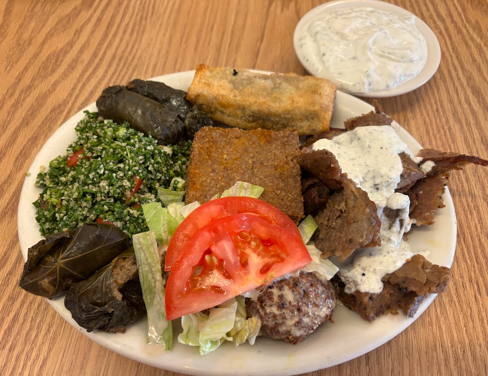 Combination plate served with gyro meat, sanbusek, tabouli, kibbi, stuffed grape leaves,...