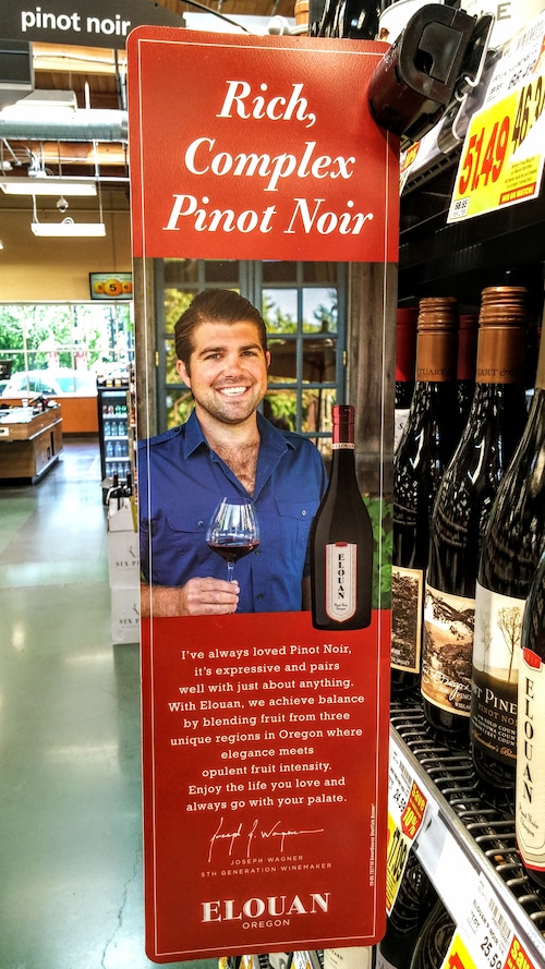 Amid wines, a grocery aisle display features Elouan wines and Copper Cane owner Joe Wagner.