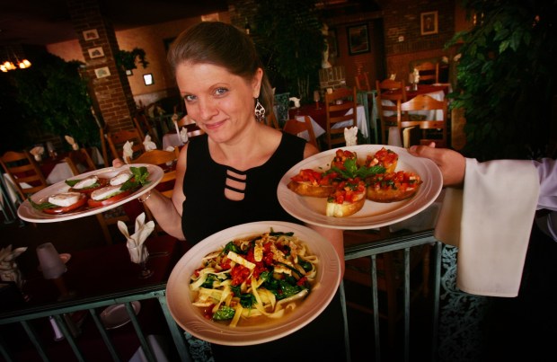 Ruthie Felix of Isabella's Italian Ristorante in Redlands shows off some of its popular dishes in 2007. (Photo by Kurt Miller, The Press-Enterprise/SCNG)