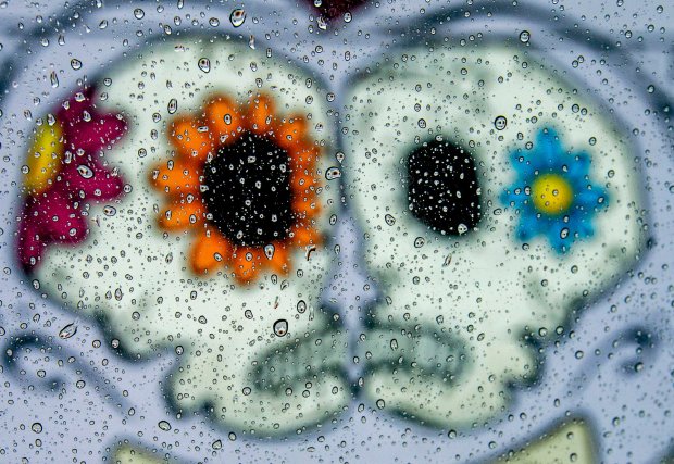 Colorful artwork fills a wall on the side of Placita as rain drops beed on a car window in Riverside on Friday, Jan. 29, 2021. (Photo by Terry Pierson, The Press-Enterprise/SCNG)