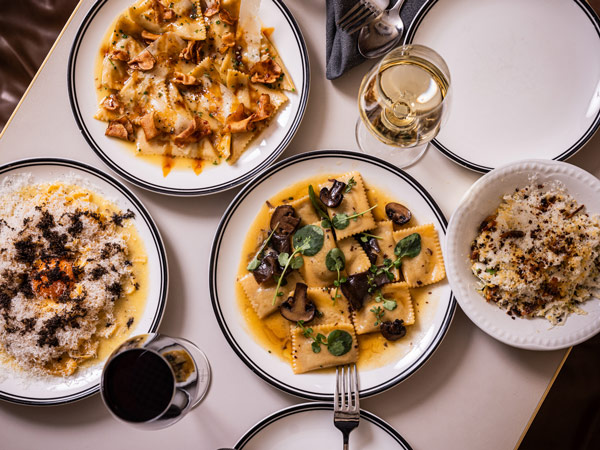 a table-top view of Italian dishes with wine at Ragazzi, Sydney