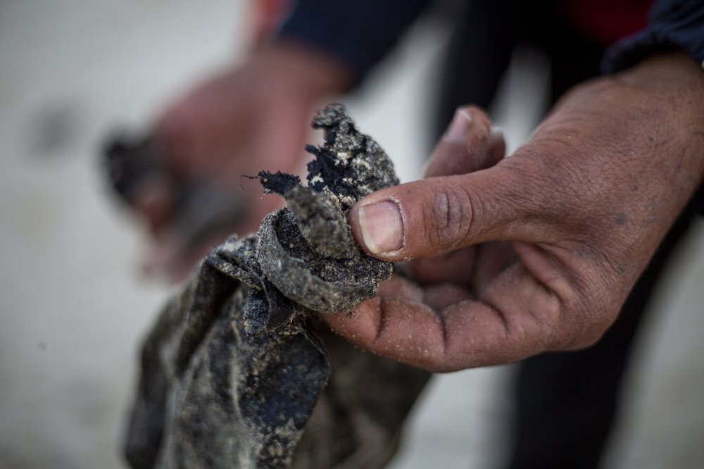 A local fisherman holds tar that washed on to the docks from an oil spill in the Mediterranean Sea, in the Arab village of Jisr al-Zarqa (Photo: AP) A local fisherman who goes by the name Jumbo holds tar that washed on to the docks from an oil spill in the Mediterranean Sea, in the Israeli Arab village of Jisr al-Zarqa