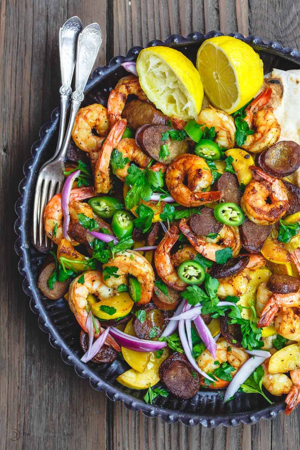 Skillet Shrimp Recipe with Chorizo and Squash | The Mediterranean Dish. Easy recipe for Spanish inspired skillet shrimp with flavors like smoked paprika and cumin. We add Spanish Chorizo and summer squash to complete the feast! Cooks in 20 minutes! From TheMediterraneanDish.com