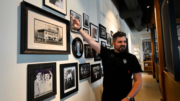 Trani's Dockside, a new waterside restaurant launched by one of the port town's best known restaurant families is preparing to open this month, with a date yet to be announced, in San Pedro on Tuesday, May 16, 2023. Renowned chef Dustin Trani points out his grandparents on the wall of historical images depicting a who's who of San Pedro. (Photo by Brittany Murray, Press-Telegram/SCNG)