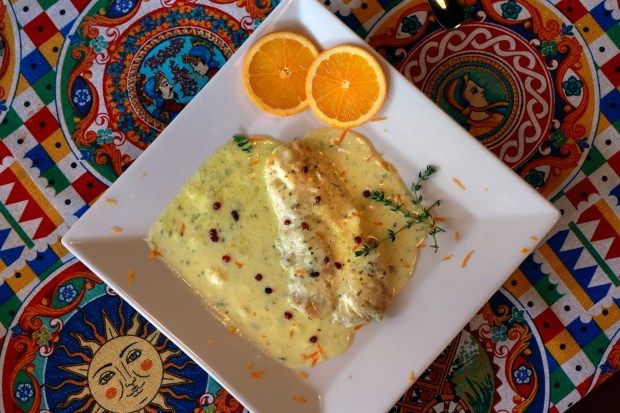 Grouper in orange sauce: Grouper fillet cooked in garlic butter with orange juice, Mt. Etna herbs, white wine, heavy cream, and red pepper at Savia Restaurant in Boca Raton at Mizner Plaza. Chef David Vito Quaderno opened the restaurant to bring authentic Sicilian cuisine to South Florida. His family has been in the restaurant provisions supply business in Sicily since the late 1800s. (Mike Stocker/South Florida Sun Sentinel)