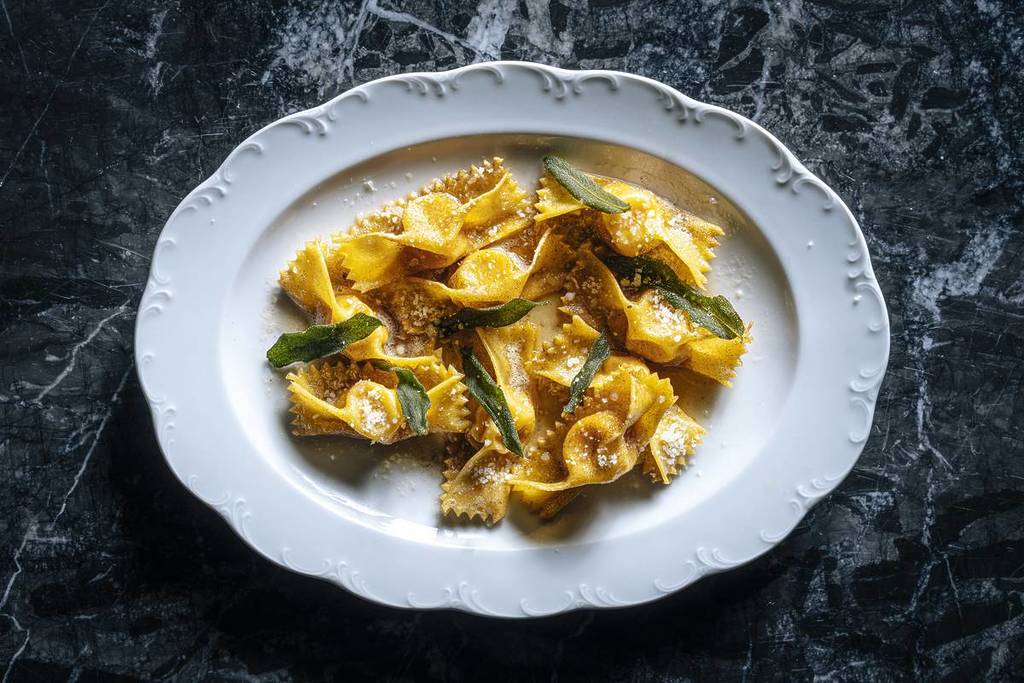Tortelli di Zucca on a white plate from Tre Dita in the St. Regis the best new restaurants in Chicago