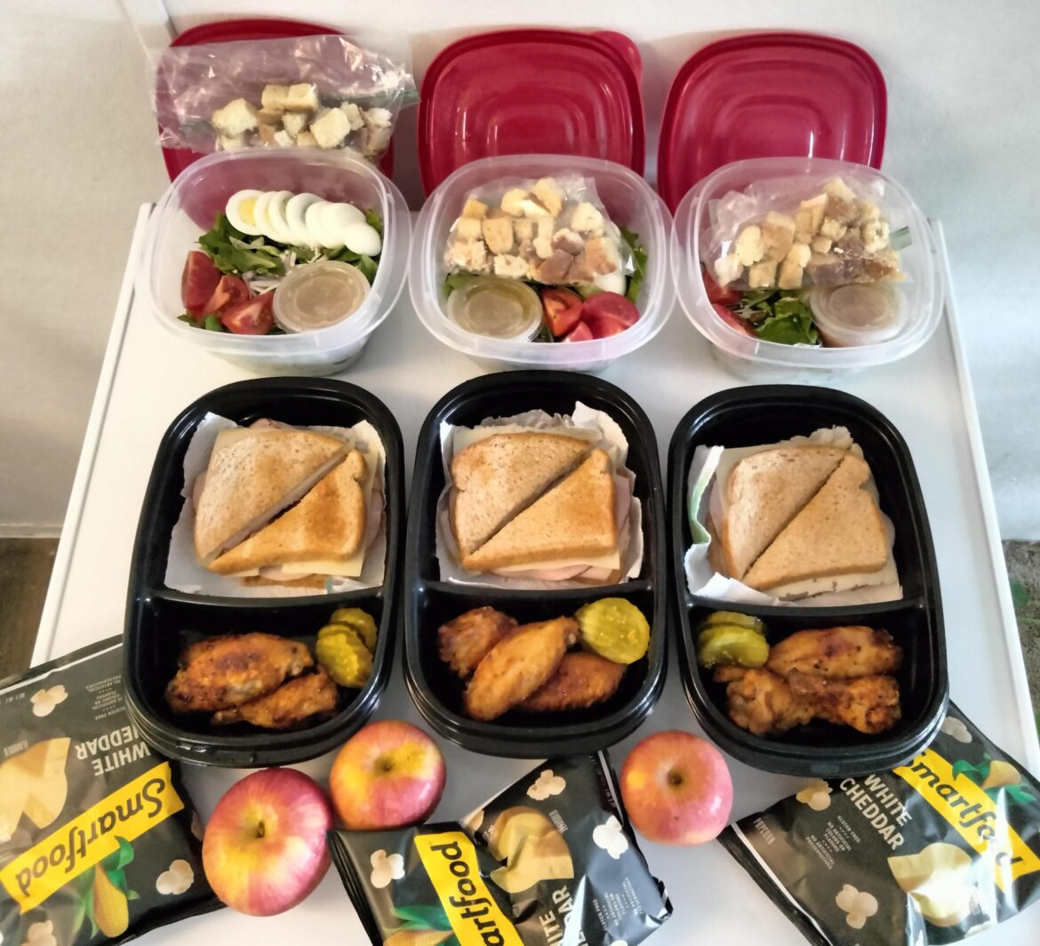 Work meals for the week: green salads with sweet onion vinaigrette, club sandwiches, spicy baked wings, and snacks. I work three twelves this week and eat all my food at work during an eight-hour window.