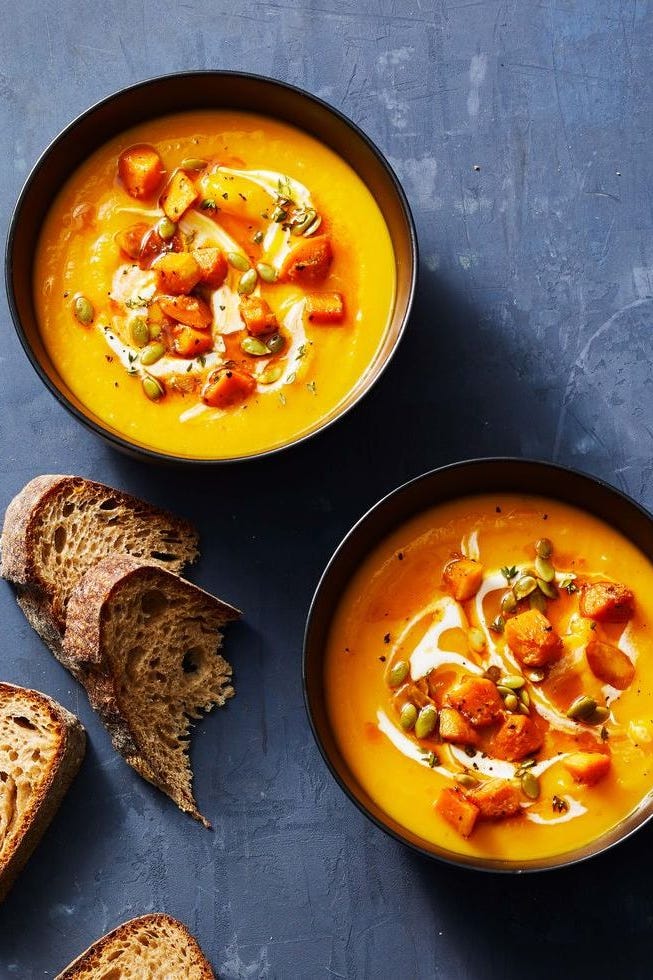 healthy air fryer squash soup in a bowl with a side of bred on the side