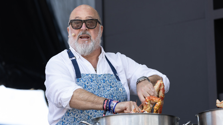 Andrew Zimmern cooking crab at a food event