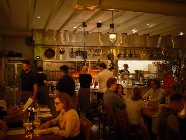 Patrons dine in Antico Nuovo's dimly lit dining room