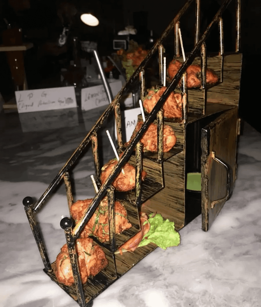 A mini staircase of chicken bite appetizers.