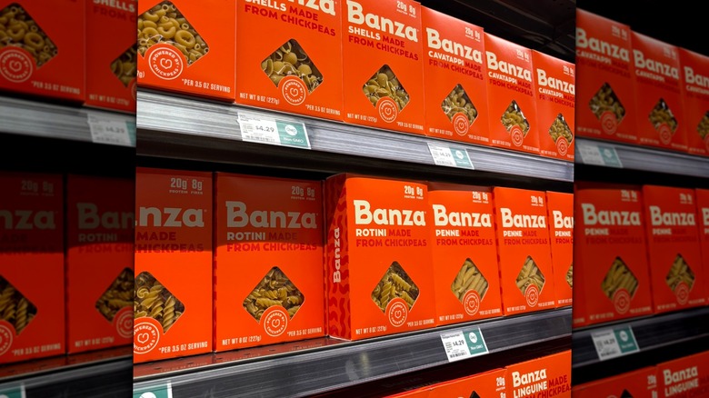 Orange boxes of shells and rotini pasta on store shelves