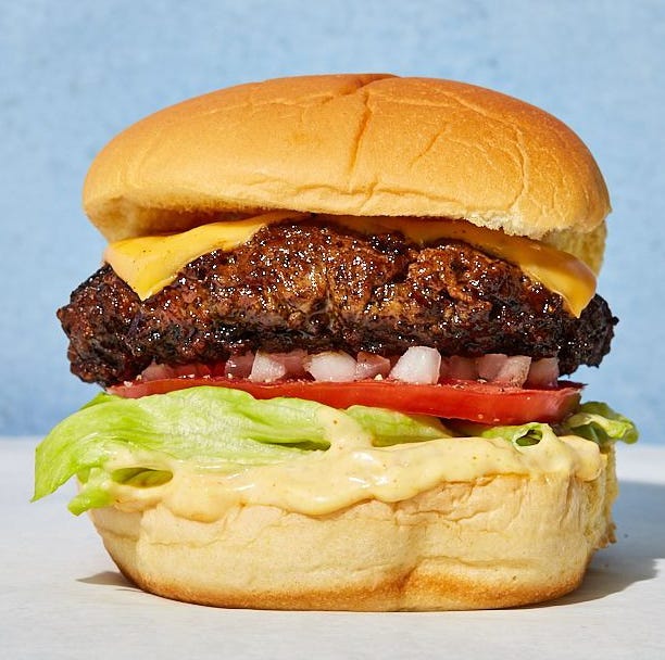 cheeseburger with onions, tomatoes, lettuce and sauce