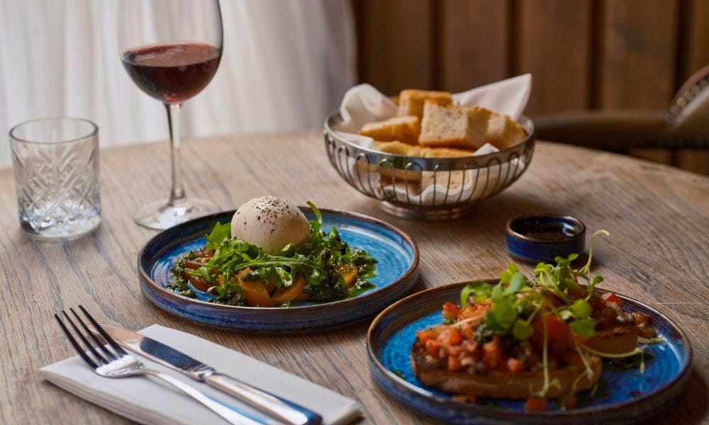 blue plates with burrata and bruschetta