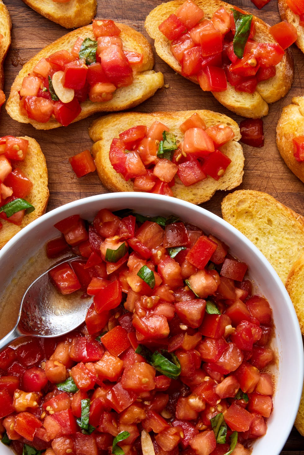 bruschetta spooned on top of slices of a toasted baguette