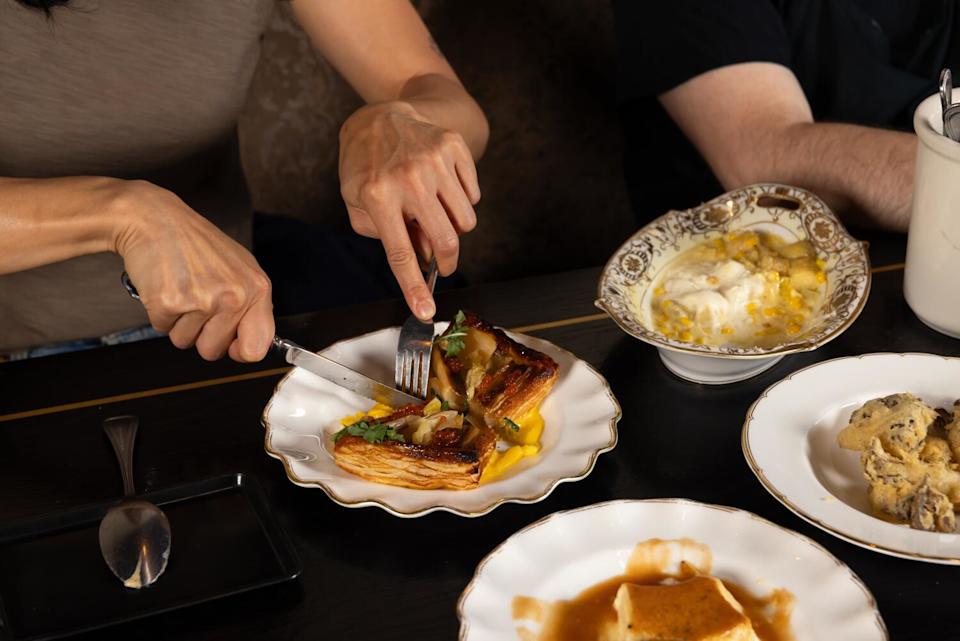 Ann Hsing digs into a test version of a leek tart at the restaurant.