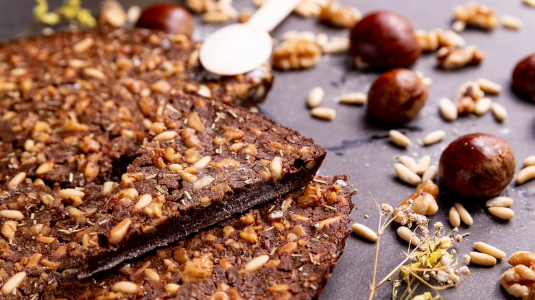 Sliced castagnaccio and various nuts
