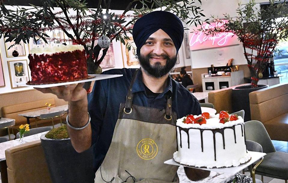 Rustika Cafe & Bakery owner Navdip Singh shows off two of the many cakes available at the new bakery and restaurant located at Herndon and Willow avenues in Clovis.