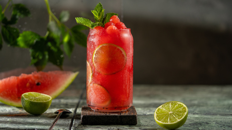 Red cocktail with limes, watermelon, and mint