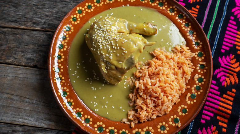 Traditional mexican chicken with green mole sauce and red rice