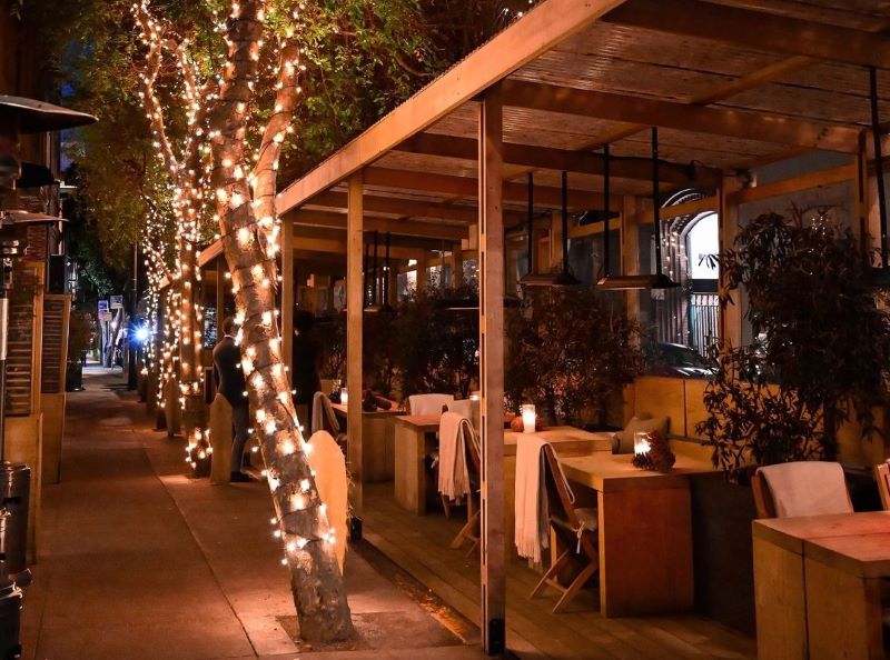 Cotogna restaurant's parklet with a tree decorated in lights