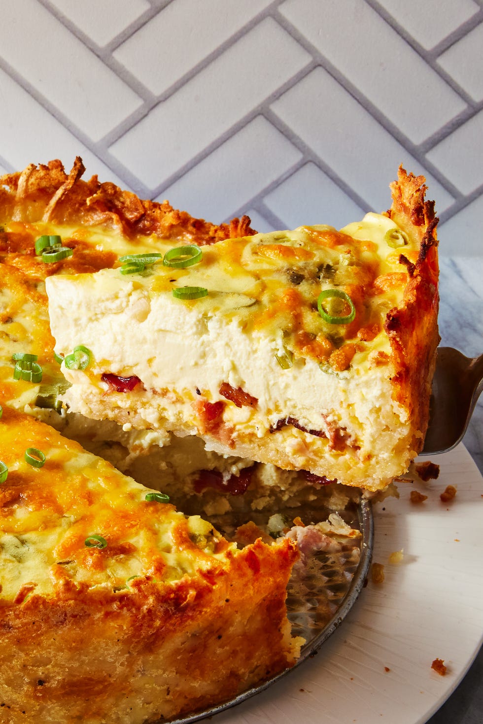 crispy hash brown crusted bacon cheddar quiche sprinkled with chives